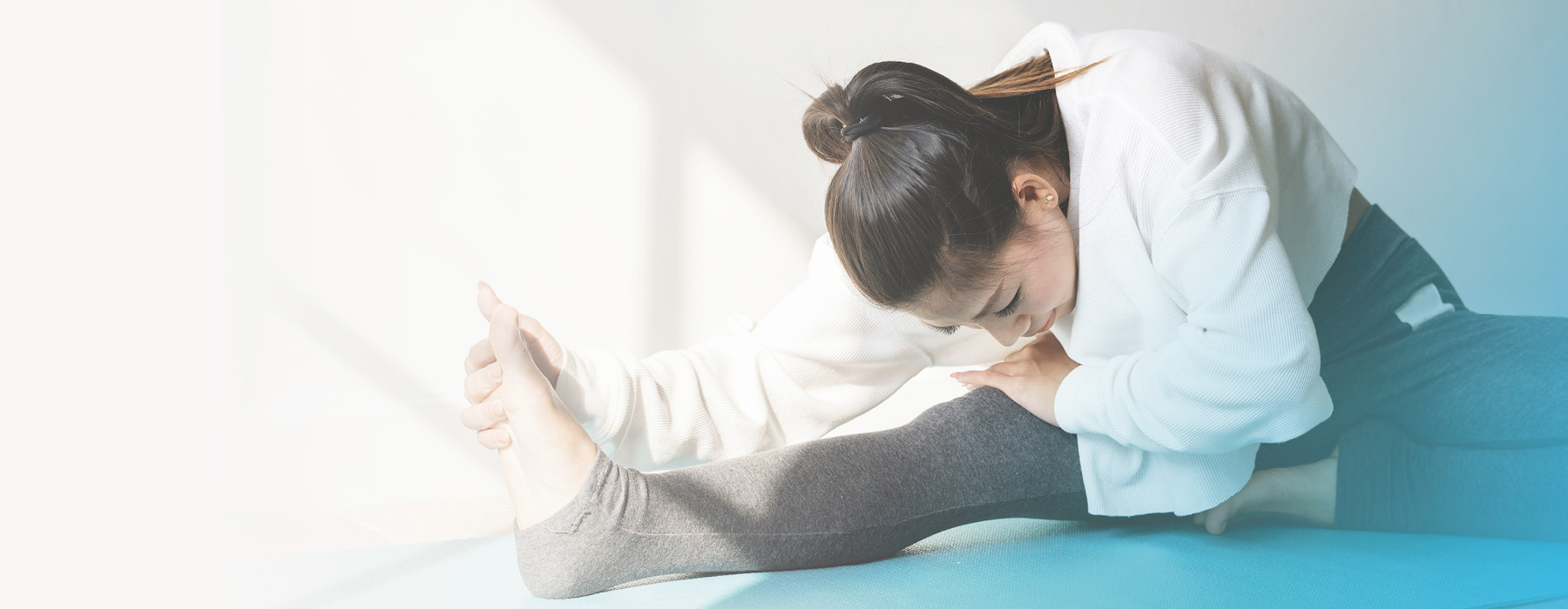 Woman stretching in yoga studio.