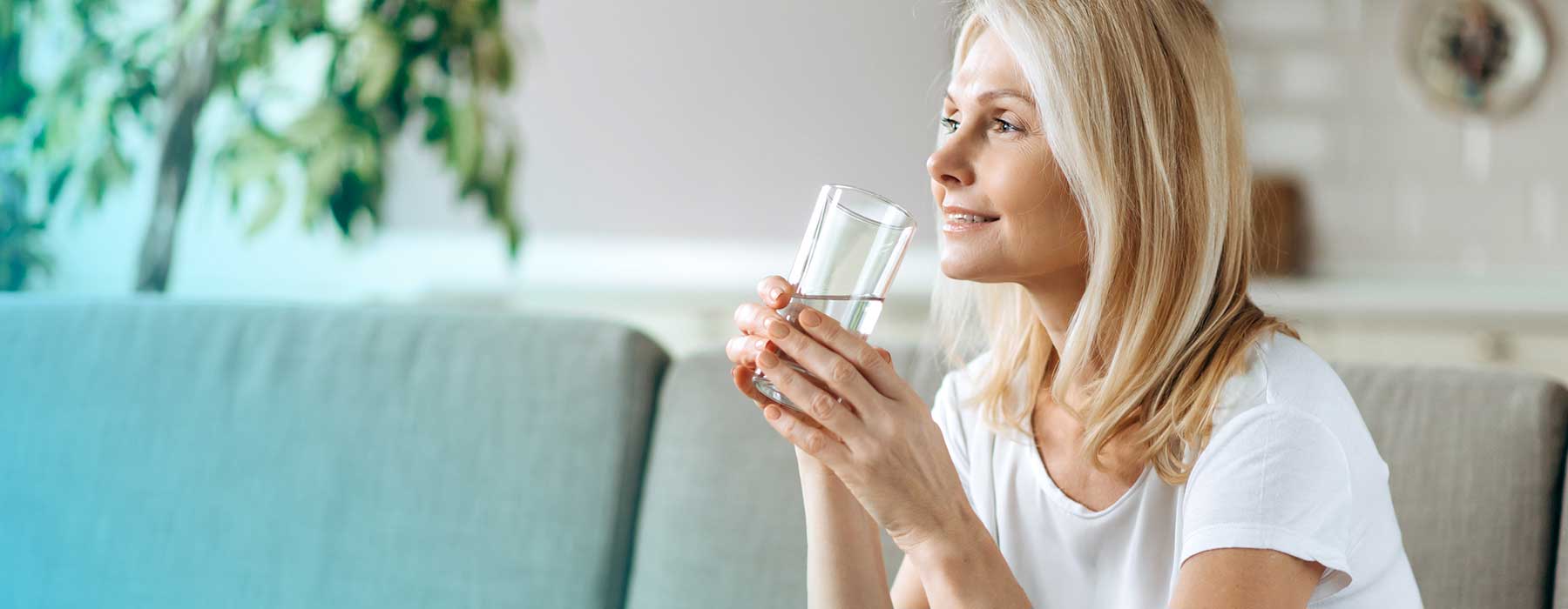Woman drinking water with Skybright Concentrated Mineral Drops added.