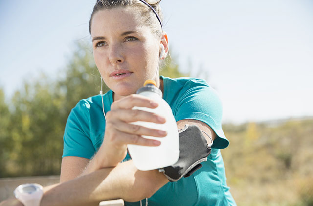 Woman drinking Skybright Performance Electrolytes from water bottle