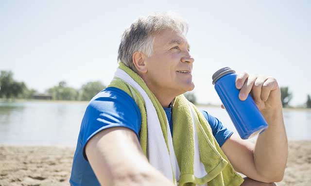 Man drinking Skybright Performance Electrolytes from water bottle.