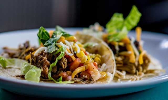 Tacos on a plate with barbecue sauce made with Organic Apple Cider Vinegar.