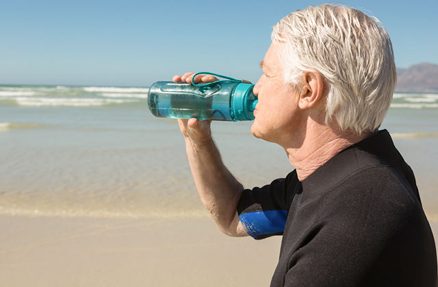 Man drinking water from water bottle.