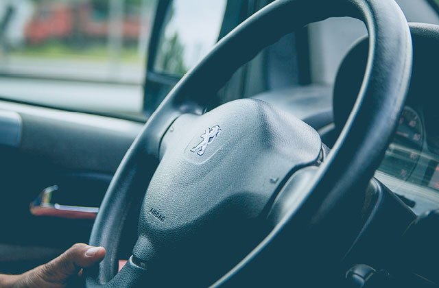 Close up of steering wheel inside car. Spray or wipe with Colloidal Silver to keep free from bacteria.