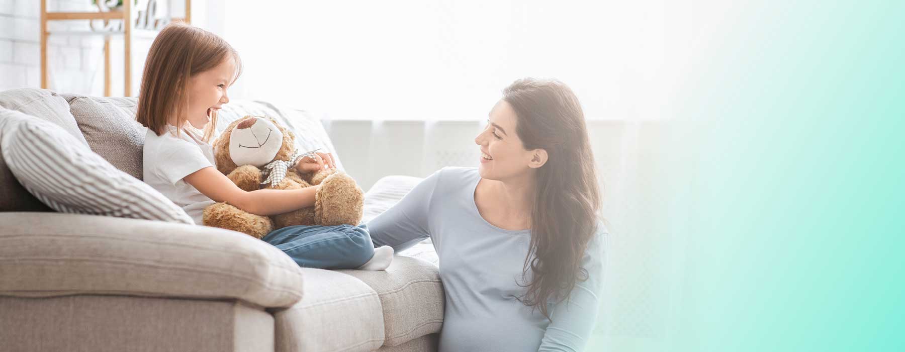 Woman with young child on sofa clutching her soft toy. Using Colloidal Silver around the home.