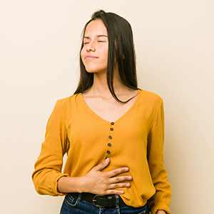 Young woman holding her stomach.