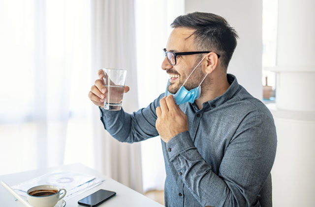 Man drinking water with Skybright Selenium liquid mineral. In New Zealand, the recommended daily intake (RDI) for selenium is 60mcg for women and 70mcg for men.