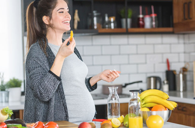 Woman eating oranges while pregnant. An intake of 600mg of Vitamin C has been shown to increase dietary selenium by nearly 100%.