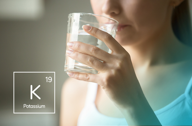 Woman drinking water with Potassium Liquid mineral added.