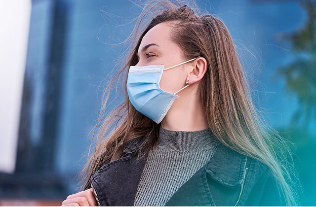 Woman wearing mask outside.