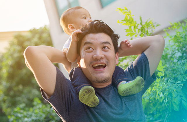 Man with infant son on his shoulders.